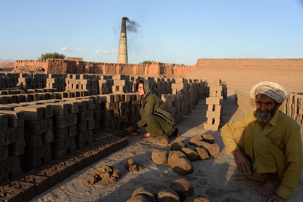 fghan female labourer Sitara Wafadar, 18, who dresses as a male in order to support her family, working at a brick factory next to her elderly father (R) in Sultanpur village in Surkh Rod district, in Afghanistan's eastern Nangarhar province. PHOTO: AFP