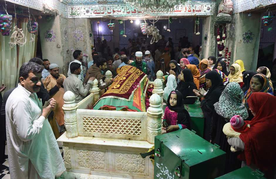 Devotees gather around the grave of Sufi Saint Abdullah Shah Ghazi at his Shrine in Karachi. PHOTO: AFP