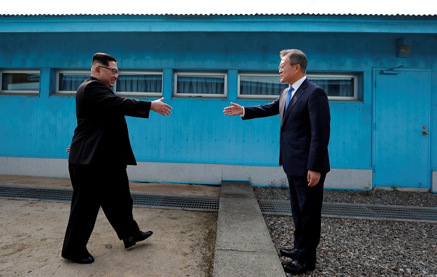 South Korean President Moon Jae-in and North Korean leader Kim Jong Un shake hands at the truce village of Panmunjom inside the demilitarized zone separating the two Koreas, South Korea, April 27, 2018. PHOTO: REUTERS