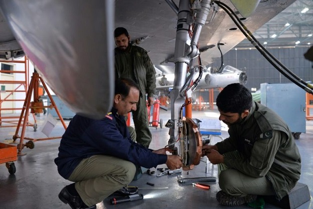 In this picture taken on December 27, 2017, technicians work on a Mirage aircraft during a full overhaul by the Pakistan Air Force (PAF) at the Mirage Rebuild Factory (MRF) in Kamra, west of the capital Islamabad. PHOTO: AFP