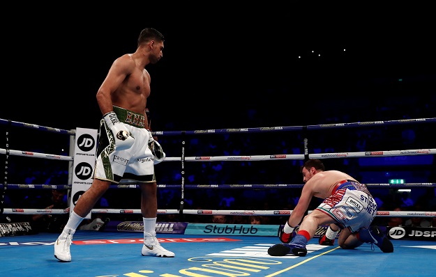 Amir Khan knocks down Phil Lo Greco. PHOTO: REUTERS