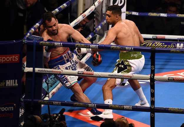 Amir Khan (R) fights Canada's Phil Lo Greco in their Super-Welterweight contest at the Echo Arena in Liverpool, northern England, on April 21, 2018. PHOTO: AFP