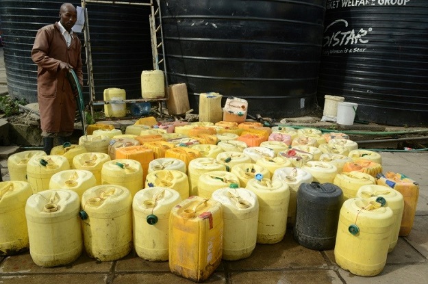 Waterboys supply water to butchers, fishmongers and restaurants in the crowded Kenyatta market. PHOTO: AFP