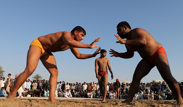  In this file photo taken on March 16, 2018 Pakistani immigrant workers in the United Arab Emirates take part in a Kushti competition in Dubai. Kushti is popular in India, Pakistan and Bangladesh and was developed in the Mughal era by combining native 'malla-yuddha' wrestling with Persian 'pahlavani'. Every Friday evening in Dubai's bustling Deira district, a sandy lot is transformed into the ring of champions. It is kushti wrestling night and Kala Pehlwan is ready to fight. PHOTO: AFP