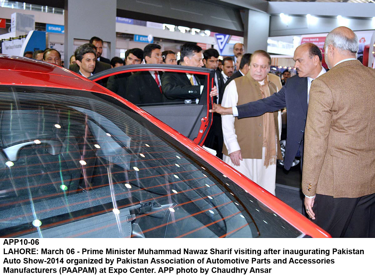 prime minister nawaz sharif c is given a tour of the pakistan association of automative parts and accessories manufacturers show at the lahore expo centre on thursday photo app