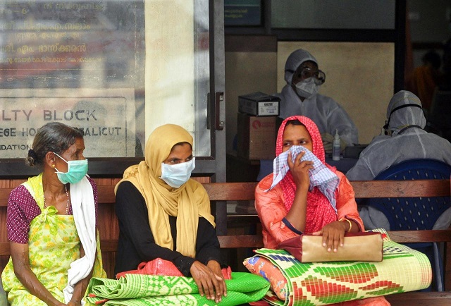 people wear masks as they wait outside a casualty ward at a hospital in kozhikode in the southern state of kerala india may 23 2018 photo reuters