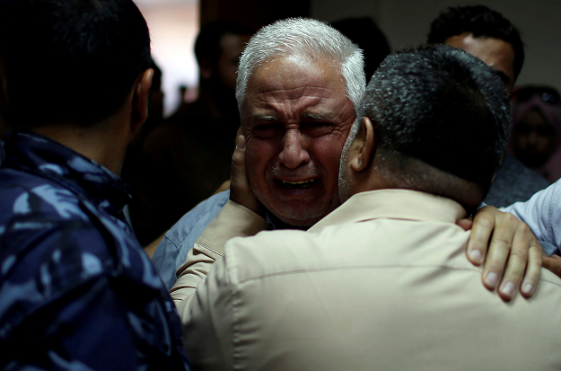 A relative of Palestinian Ahmed al-Rantisi, who was killed during a protest at the Israel-Gaza border, is consoled at a hospital in the northern Gaza Strip May 14, 2018 PHOTO: REUTERS