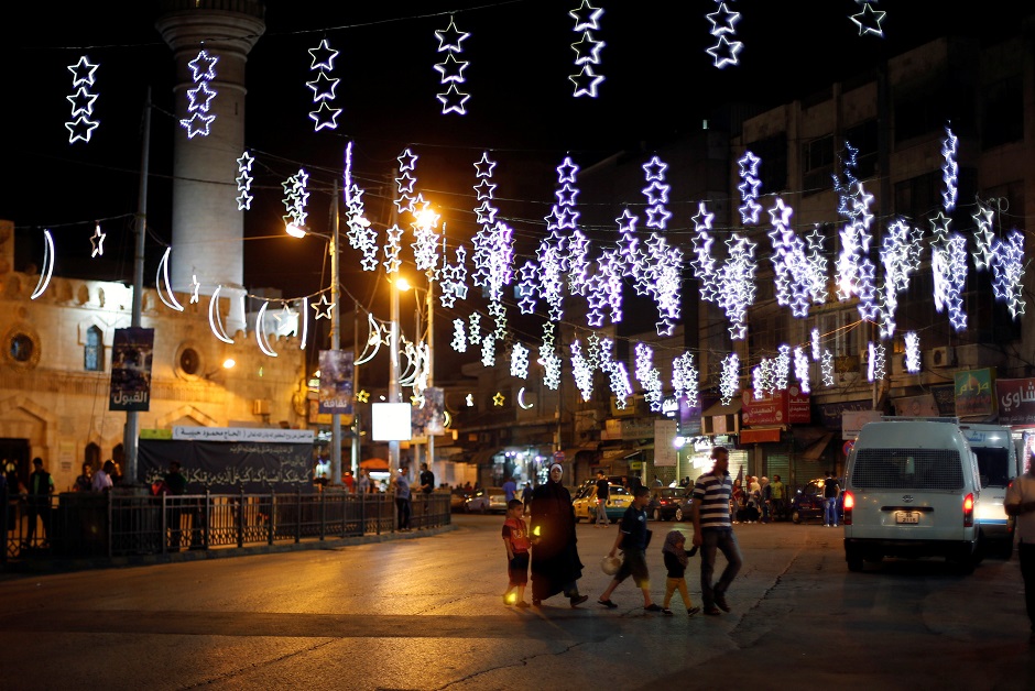 People walk at a street decorated for the holy fasting month of Ramadan in Amman, Jordan. PHOTO: REUTERS