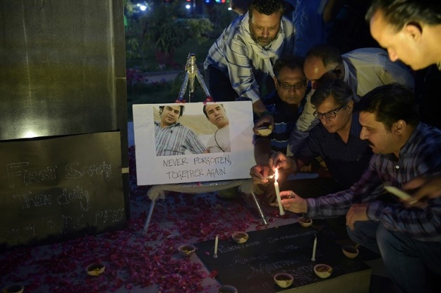 Journalists around the world have mourned the killing of AFP's Shah Marai, pictured here with Sardar Ahmad -- an AFP reporter who was killed in a 2014 attack alongside his wife and children. PHOTO: AFP