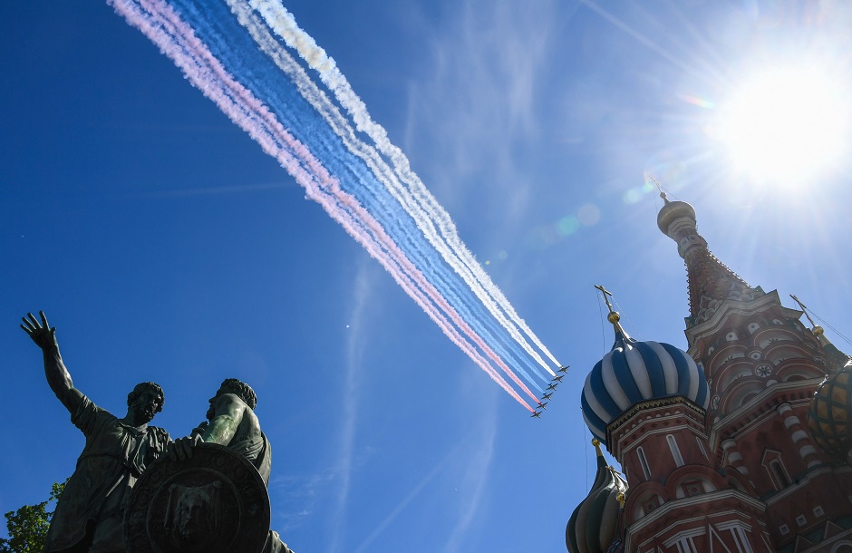 Russian Su-25 assault aircrafts release smoke in the colours of the Russian flag while flying over Red Square. PHOTO: AFP