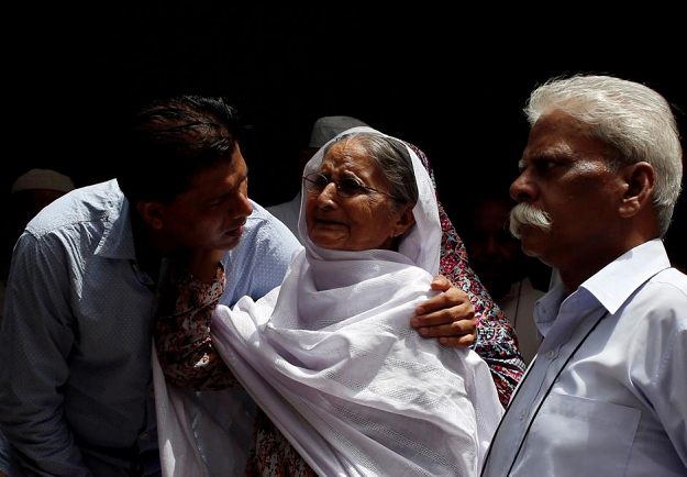 Aziz Shaikh (L), father of Sabika Aziz Sheikh, a Pakistani exchange student, who was killed with others when a gunman attacked Santa Fe High School in Santa Fe, Texas, U.S., comforts a relative in Karachi, Pakistan May 19, 2018 PHOTO: REUTERS