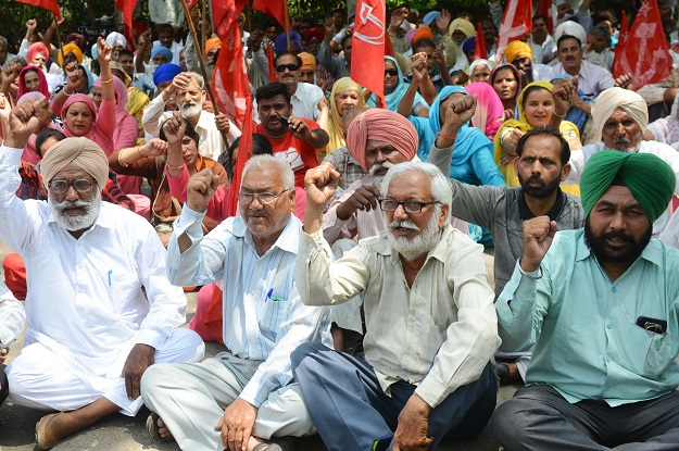 Indian activists from the Communist Party of India (Marxist) (CPI-M), along with factory workers, shout slogans during a protest against alleged anti-workers policies imposed by the state and central governments on the occasion of International Labour Day, in Amritsar. PHOTO: AFP