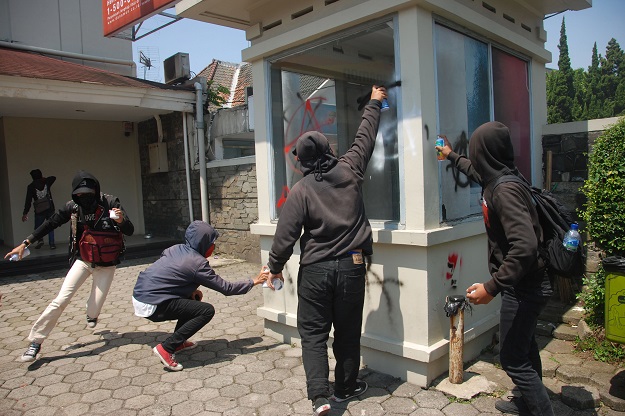 Members of an Indonesian counterculture movement vandalise a booth as they take part in a protest to mark May Day in Bandung. PHOTO: AFP