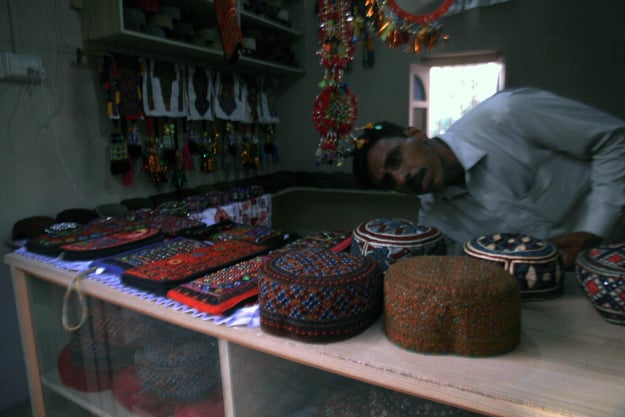 A vendor displaying Sindhi topis and other crafts. PHOTO: ATHAR KHAN