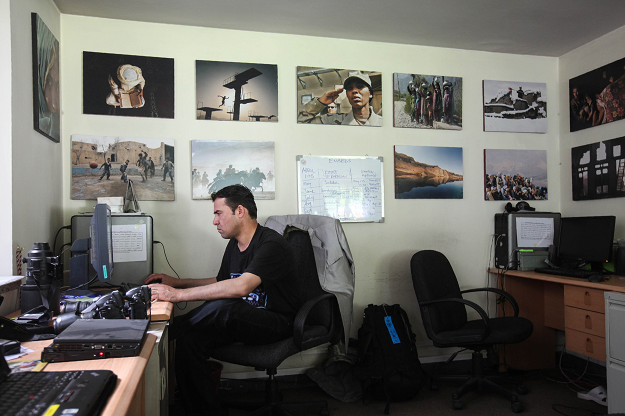 AFP chief photographer for Afghanistan Shah Marai sits at his desk at the AFP office in Kabul PHOTO: AFP