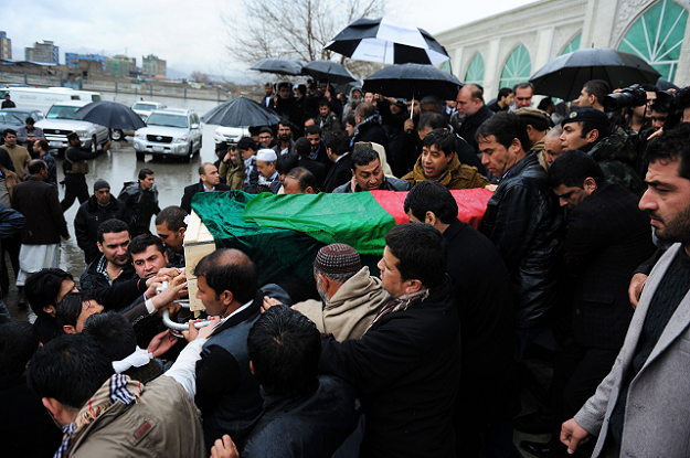 Shah Marai (3R) along with friends and family of Afghan reporter Sardar Ahmad carry his casket as they leave a mosque and head to the cemetary during his funeral in Kabul PHOTO: AFP