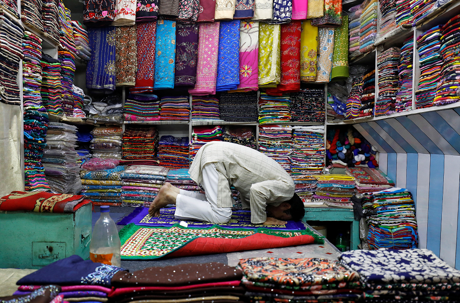  A man prays in his shop after iftaar in New Delhi, India. PHOTO: REUTERS/ Saumya Khandelwal.