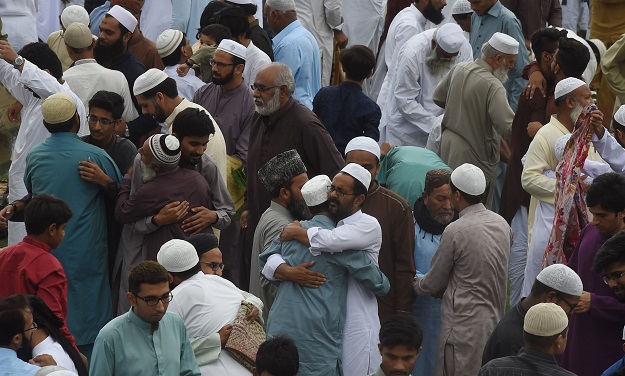 Pakistani Muslims exchange Eid greetings to one another after offering Eid al-Fitr prayers at an Eidgah ground in Karachi on June 16, 2018. Muslims around the world are celebrating the Eid festival, marking the end of the fasting month of Ramadan. PHOTO: AFP