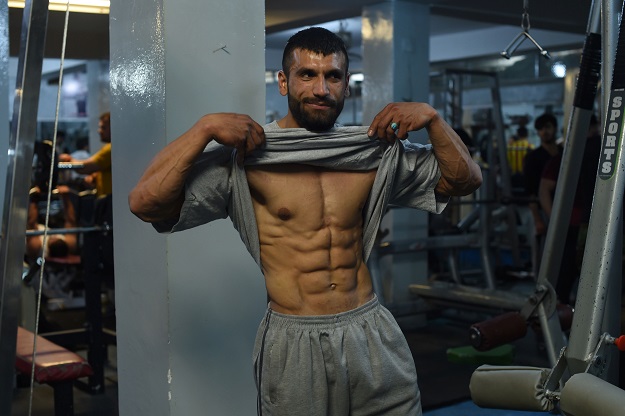 Afghan bodybuilder Hares Mohammadi, 25, posing as he exercises at a gym in Kabul. PHOTO: AFP