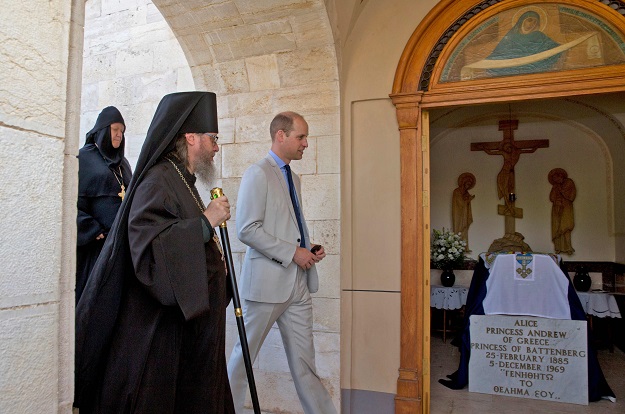 Britain's Prince William walks with father Roman Archimandrite during a visit to the Mary Magdalene Church, in east Jerusalem, on June 28, 2018. PHOTO: AFP