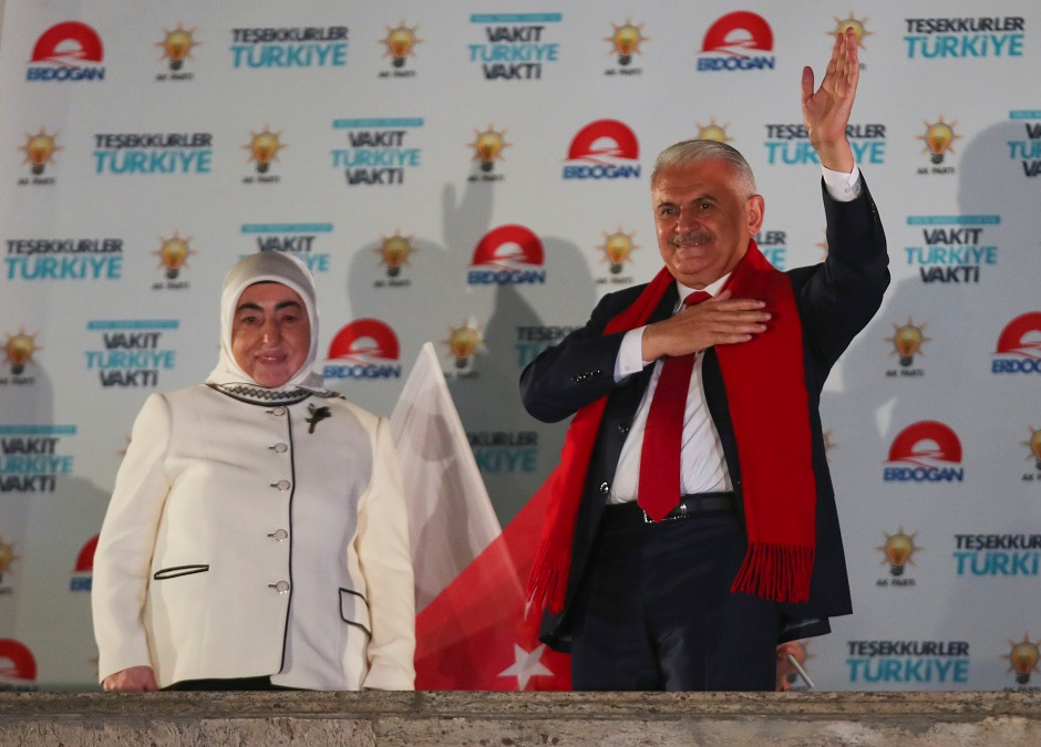 Turkish Prime Minister Binali Yildirim, accompanied by his wife Semiha, greets AK Party supporters gathered in front of the AKP headquarters in Ankara, Turkey. PHOTO: REUTERS