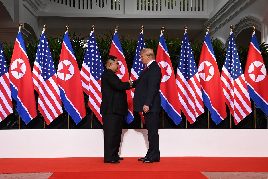 US President Donald Trump (R) shakes hands with North Korea's leader Kim Jong Un (L) at the start of their historic US-North Korea summit, at the Capella Hotel on Sentosa island in Singapore. PHOTO: AFP