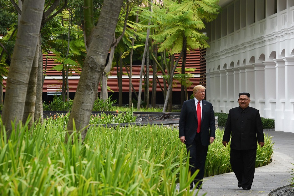 North Korea's leader Kim Jong Un (R) walks with US President Donald Trump (L) after lunch and during a break in talks. PHOTO: AFP
