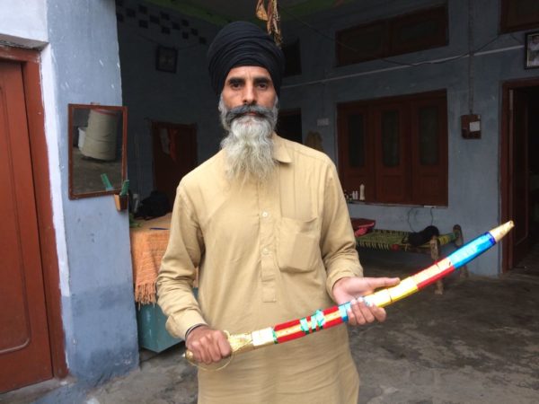 Roshan Singh, a baptised Sikh poses with a sword. PHOTO: RIAZ AHMED