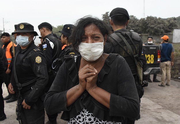  A woman cries for her missing relatives during the search for vicitms in San Miguel Los Lotes, a village in Escuintla Department, about 35 km southwest of Guatemala City, on June 4, 2018, a day after the eruption of the Fuego Volcano At least 25 people were killed, according to the National Coordinator for Disaster Reduction (Conred), when Guatemala's Fuego volcano erupted Sunday, belching ash and rock and forcing the airport to close PHOTO: AFP
