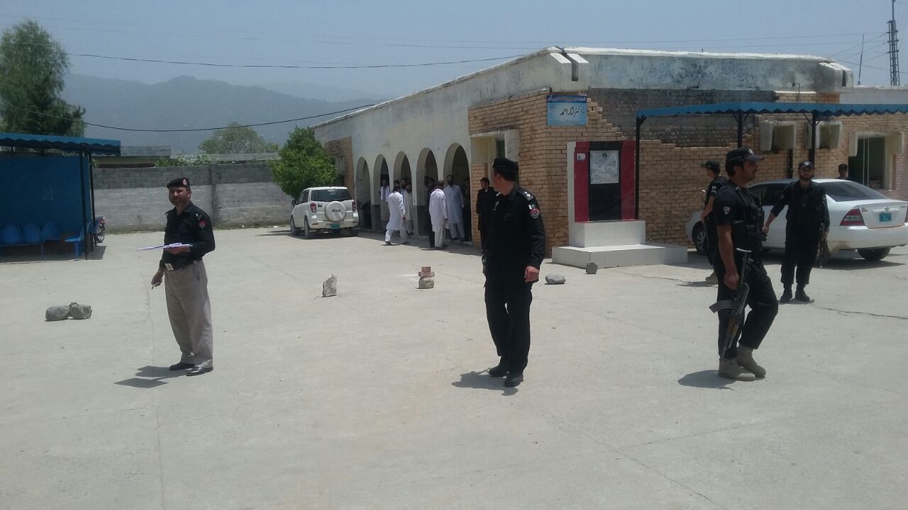 K-P Police near the crime scene. PHOTO: EXPRESS