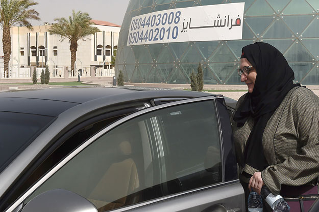 Saudi national and newly licensed Reem Farahat, an employee of Careem, a chauffeur car booking service, prepares for a customer shuttle using her car in Riyadh. PHOTO: AFP