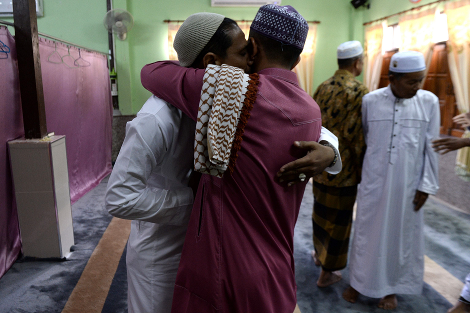 Thai Muslim men greet each other on Eid. PHOTO: AFP.