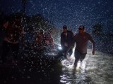 samaritans-help-push-a-boat-with-evacuees-to-high-ground-during-a-rain-storm-caused-by-tropical-storm-harvey-along-tidwell-road-in-east-houston