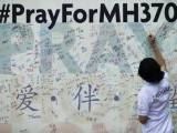a-woman-writes-a-message-on-a-board-for-family-members-of-passengers-onboard-the-missing-malaysia-airlines-flight-mh370-at-the-mca-headquarters-in-kuala-lumpur-3