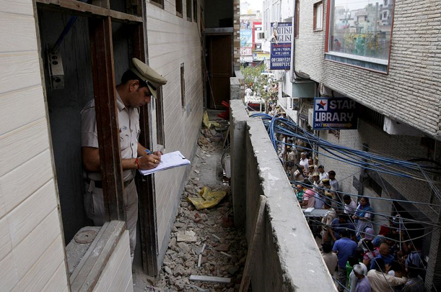 a policeman write notes in the family 039 s new delhi home during an investigation photo reuters