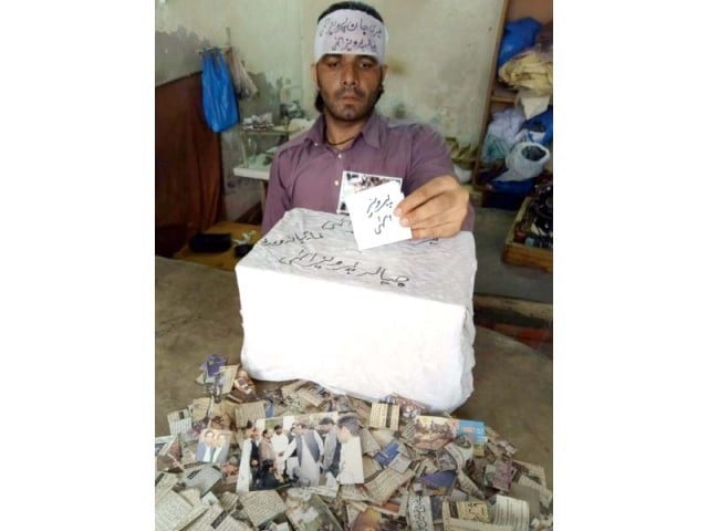 Khalid Pervez, a victim of paralysis, cast his vote into a wooden ballot box. PHOTO: EXPRESS