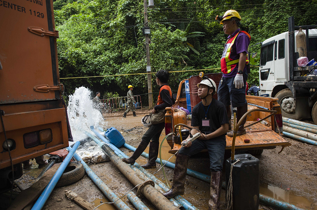 Thai rescue personnel work to pump water from the Tham Luang cave as rescue operations continue PHOTO:AFP