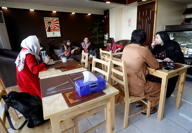 Afghan youth have coffee at a coffee shop in Kabul. PHOTO:REUTERS