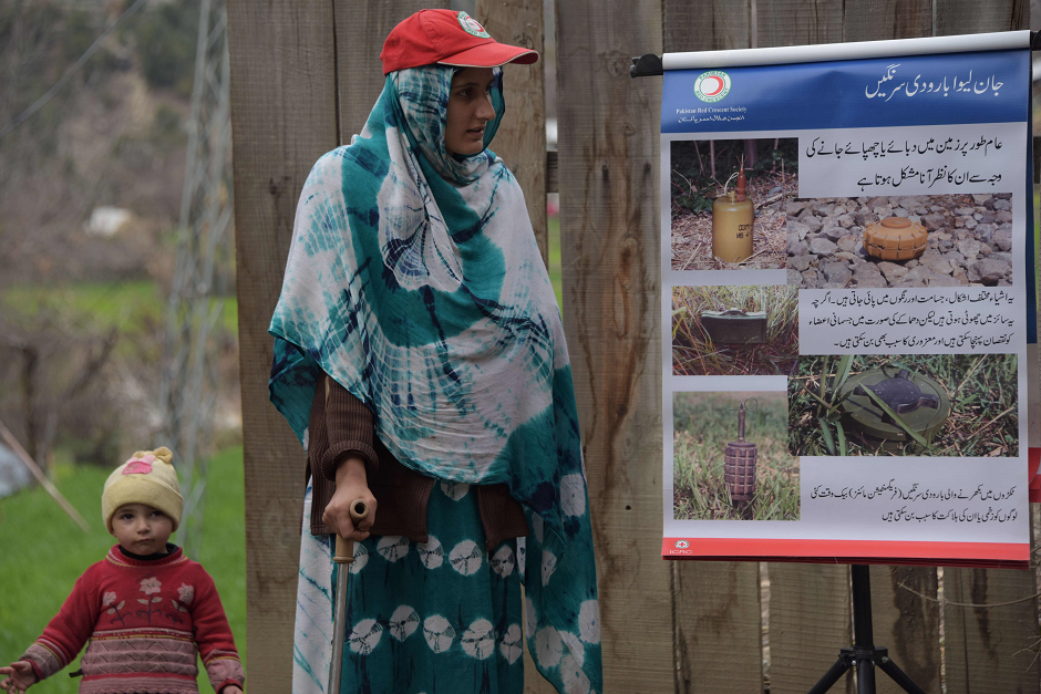 Salima Bibi, 24, a victim of landmine, wears an artificial limb before giving an awareness campaign for landmines talk to local residents at a village in Neelum Valley. PHOTO: AFP. 