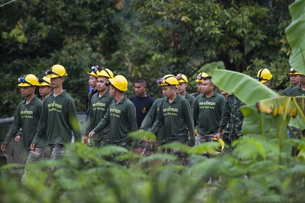 Thai soldiers walk out from the Tham Luang cave area as operations continue for the 8 boys and their coach trapped at the cave in Khun Nam Nang Non Forest Park in the Mae Sai district of Chiang Rai province on July 9, 2018. Four boys among the group of 13 trapped in a flooded Thai cave for more than a fortnight were rescued on July 8 after surviving a treacherous escape, raising hopes elite divers would also save the others soon. PHOTO: AFP