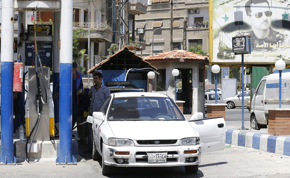 A Syrian driver pumps fuel at a gas station in the capital Damascus on July 10, 2018. Syrian authorities have began removing security barriers improving traffic in the capital. PHOTO: AFP.