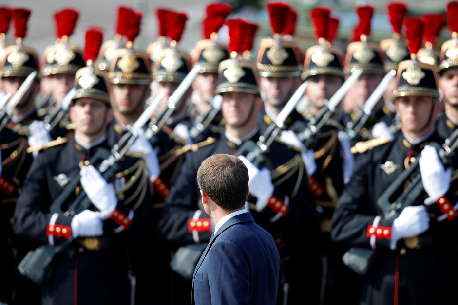 French President Emmanuel Macron stands in front of guards. PHOTO: AFP.