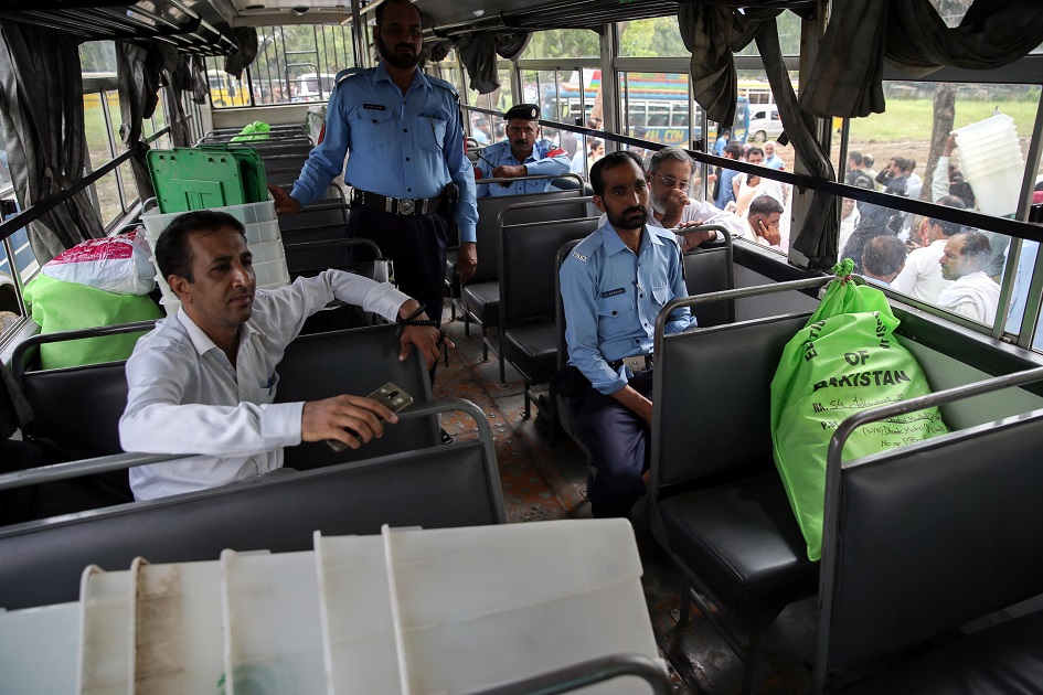  Police officers and election officials are seen inside a bus with election materials at a distribution centre ahead of general election in Islamabad. PHOTO: REUTERS