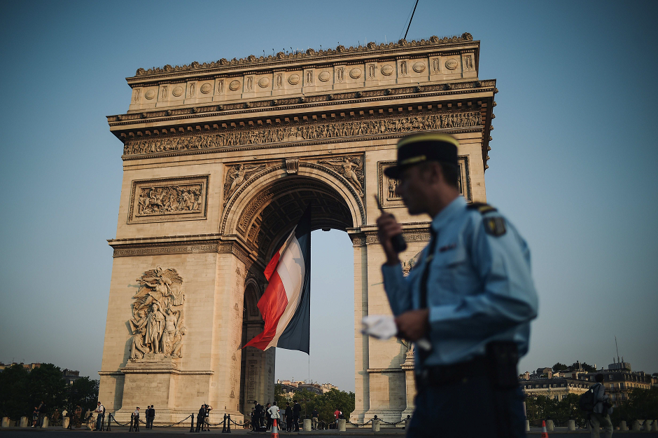 A French gendarme patrols at the Arc de Triomphe during preparations for the annual Bastille Day military parade on the Champs-Elysees avenue in Paris. PHOTO: AFP.