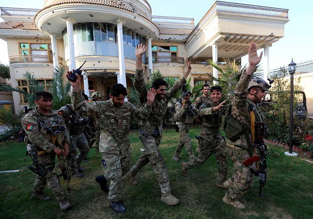 Afghan security forces celebrate their victory after insurgents attack a midwife training center in Jalalabad city, Afghanistan July 28, 2018. PHOTO: REUTERS