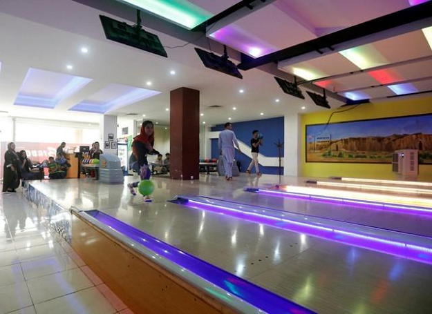 Afghan youth play at a bowling center, in Kabul. PHOTO:REUTERS