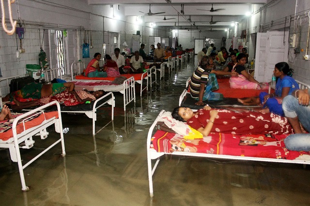 This photograph taken in July 28 shows a patients and relatives in a waterlogged ward. PHOTO: AFP