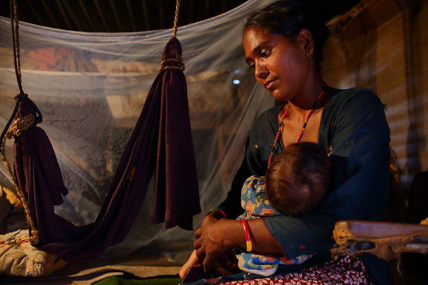 Nepali mother Sita Khatri with her young son at her home in the Ramechhap district. PHOTO: AFP.