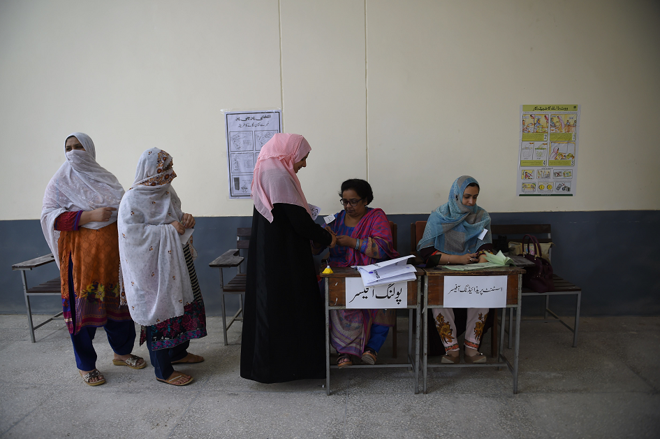 Female voters line up to vote in a polling station. PHOTO: AFP.