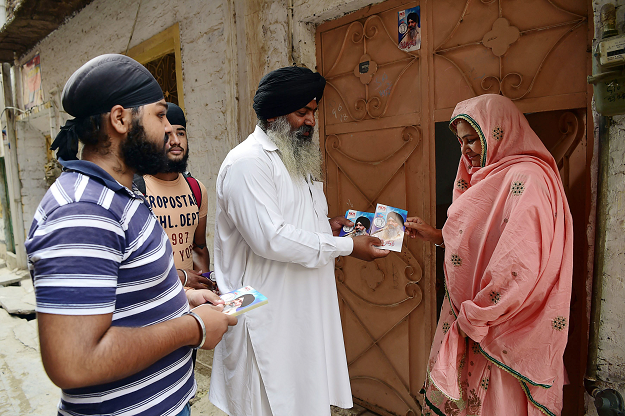Radesh Singh Tony campaigning door to door. PHOTO: AFP. 